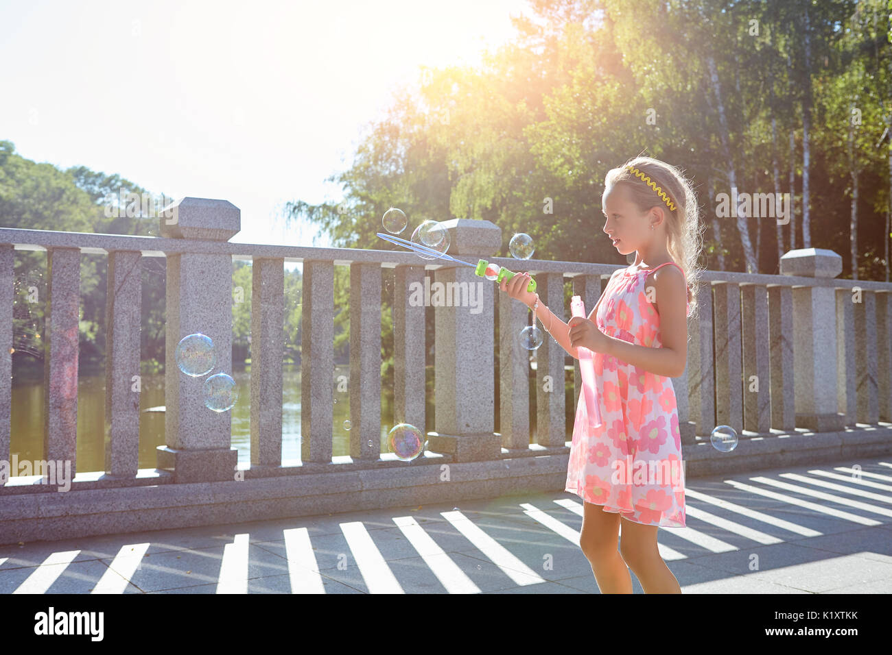 Girl with bubble blower. Child outdoors, summer day Stock Photo - Alamy