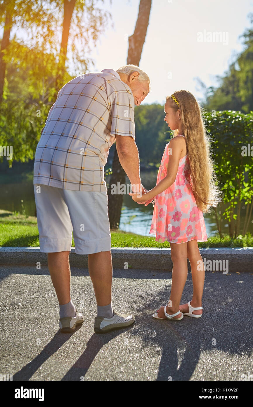 Girl with grandpa outdoors. Senior man and little girl Stock Photo - Alamy