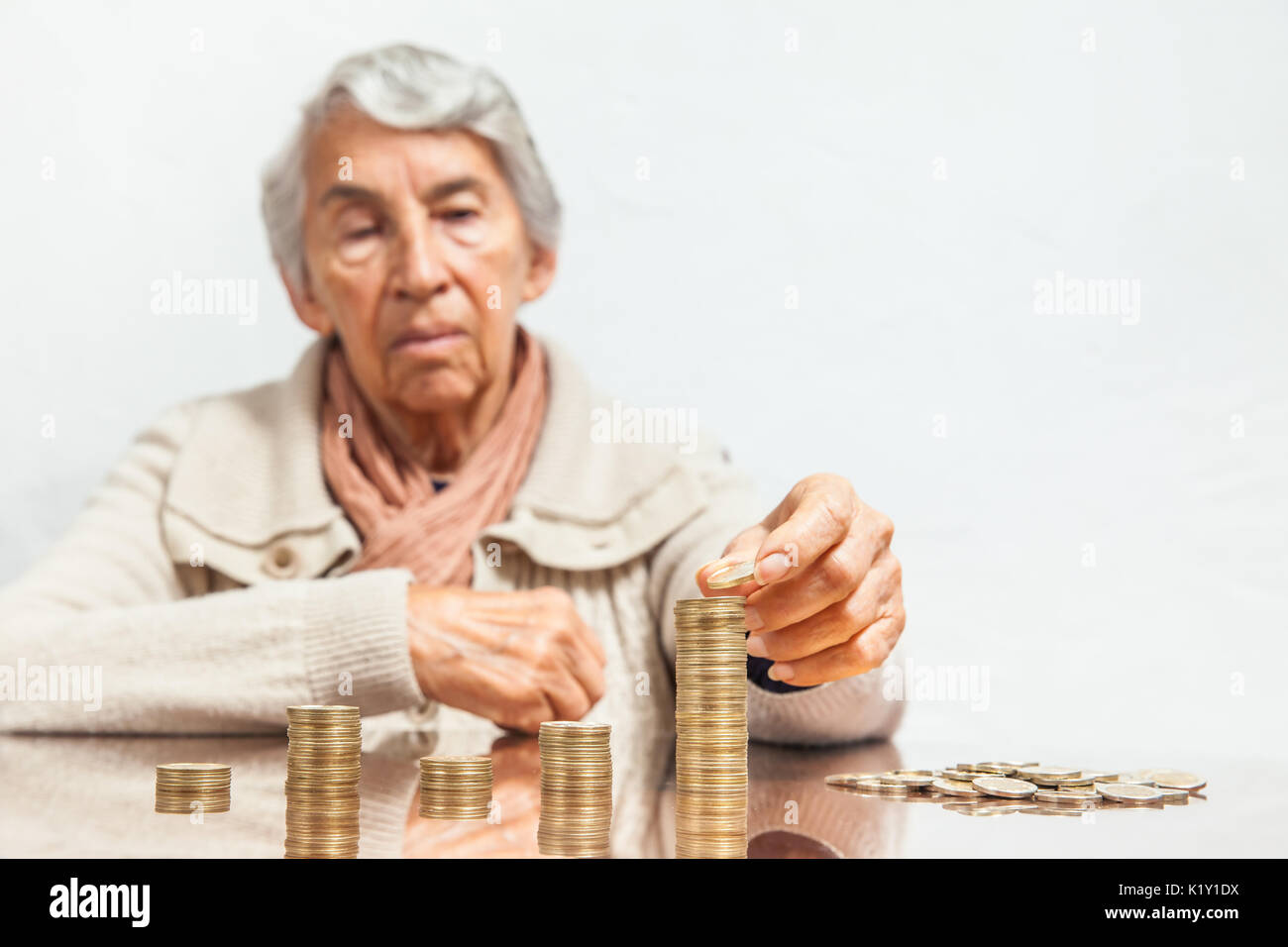 Senior woman saving money or budgeting Stock Photo