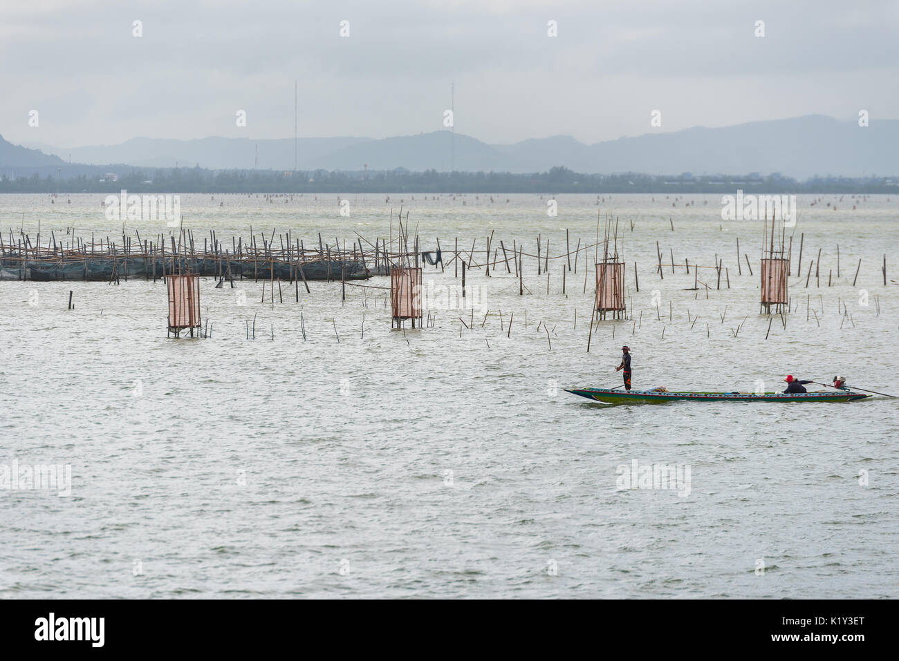SONGKHLA THAILAND - FEBRUARY 18: Two fishermen in boat that surrounded by fish traps by local knowledge at Songkhla Lake on February 18, 2017 in Songk Stock Photo