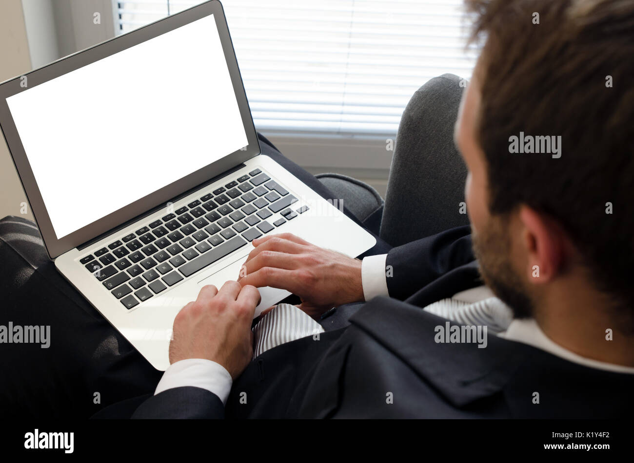 Businessman using laptop at home. Computer with blank empty screen Stock Photo