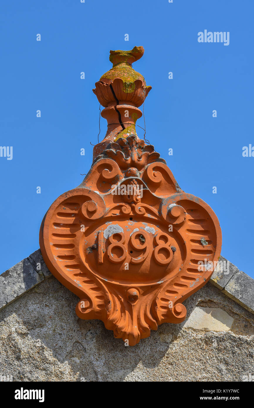 Decorative dater terracotta roof detail, France Stock Photo
