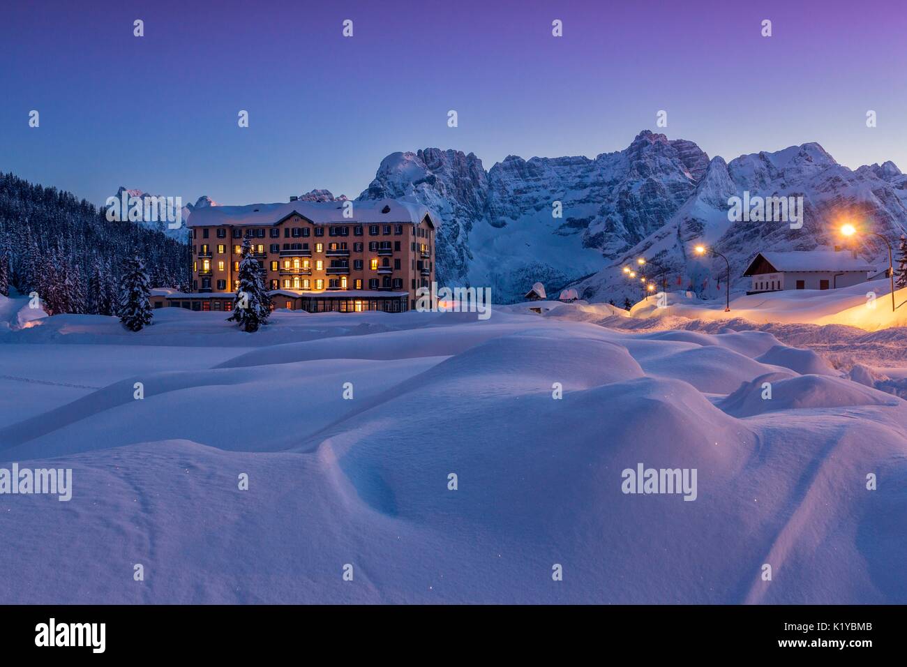 An health institution on Misurina's lake in wintertime's sunset, with peaks in the background. Auronzo di Cadore, Belluno, Dolomites, Italy Stock Photo