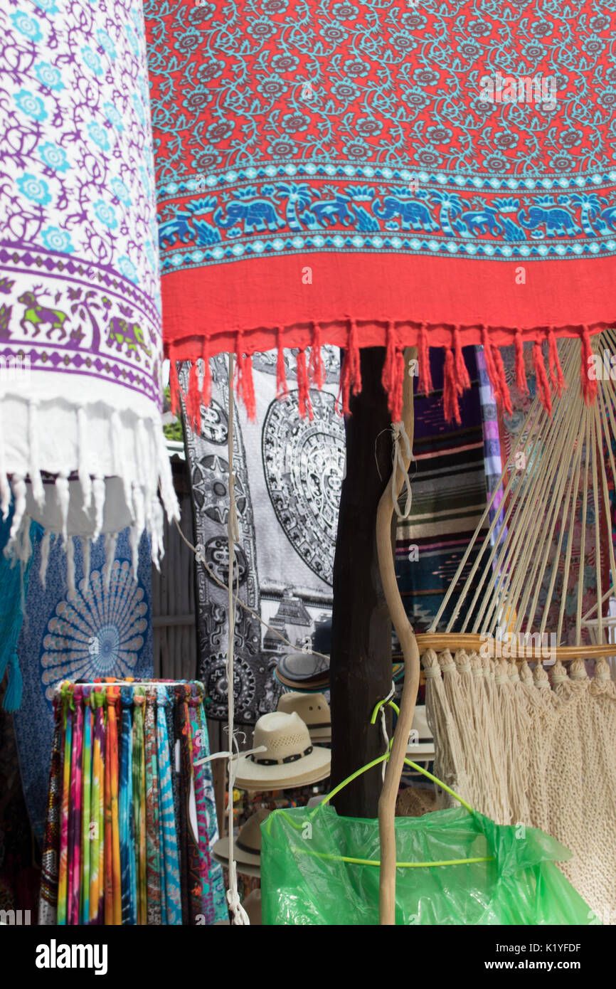 Colorful scarfs and hats at Mexican trader stall. Scarves blowing in wind. Stock Photo