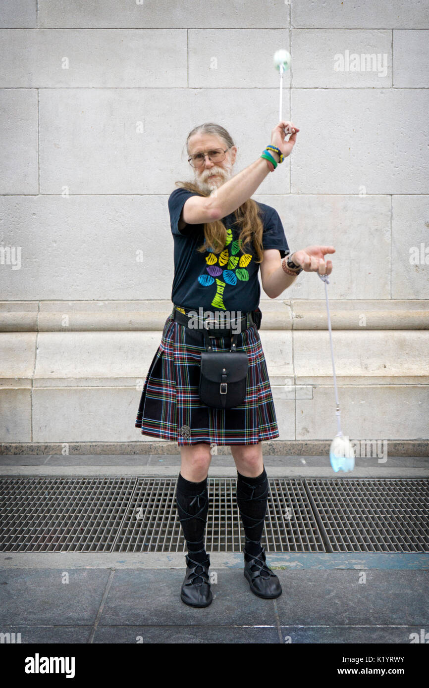 Portrait of a POI performance artist in a skirt & in his fifties,  in Washington Square Park in Manhattan, New York City. Stock Photo