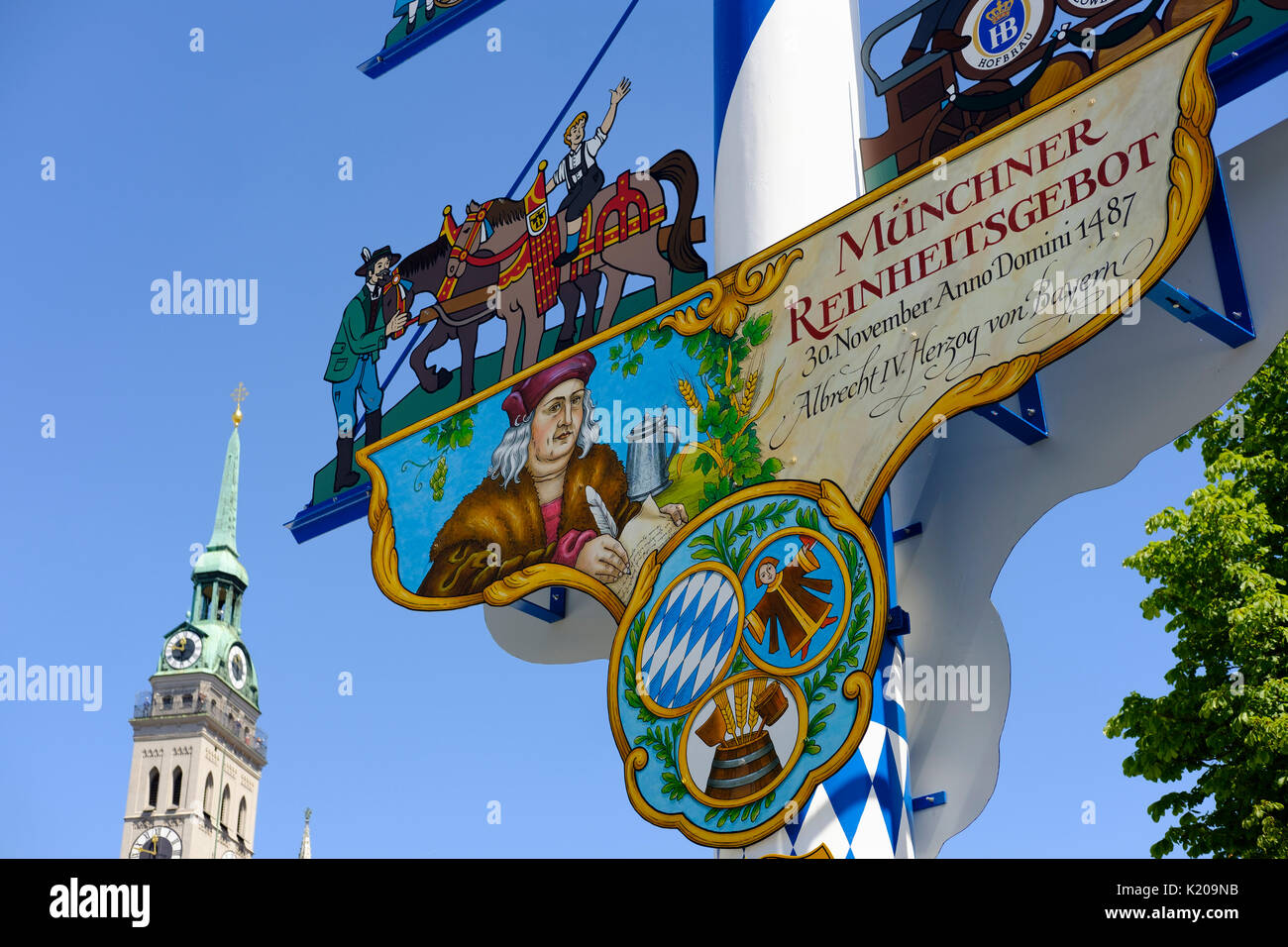 Maypole at the Viktualienmarkt, church tower Alter Peter, old town, Munich, Upper Bavaria, Bavaria, Germany Stock Photo