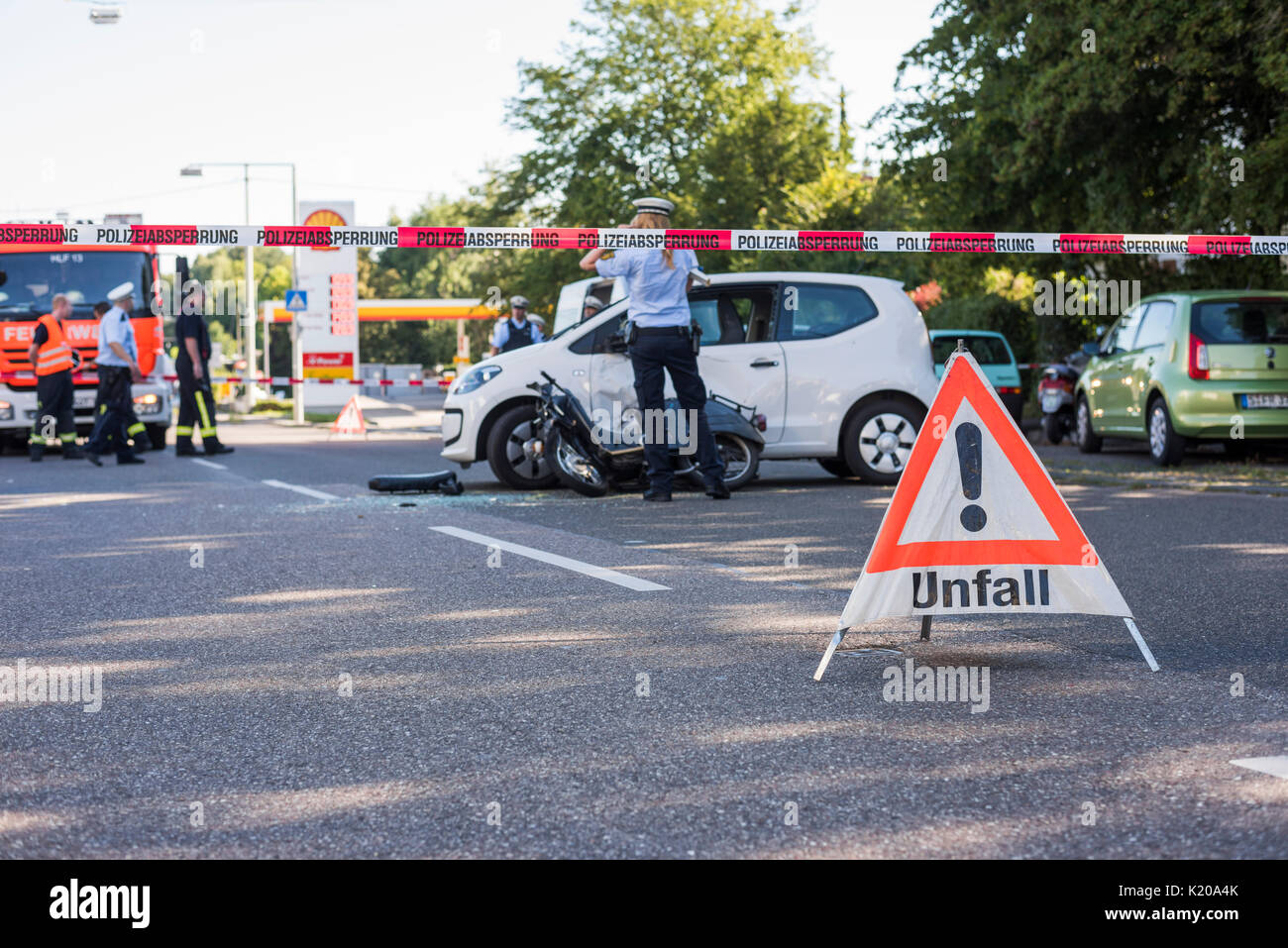 Heavy road accident, Simson scooter crashing in car, policewoman at place of accident, Germany Stock Photo