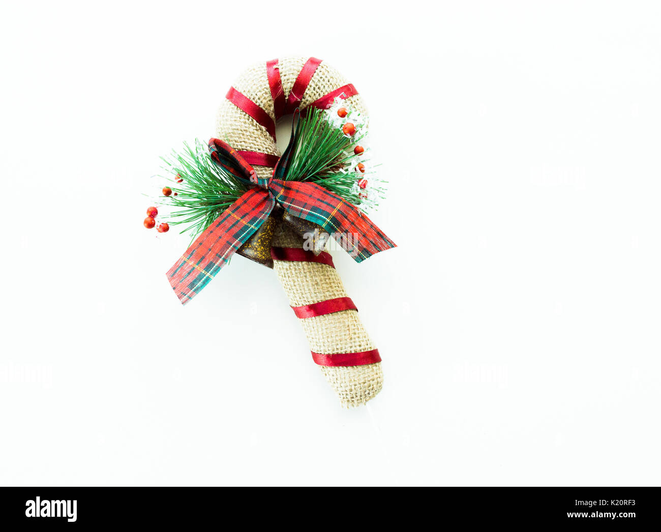 colorful plush candy cane toy with plaid bow isolated on white Stock