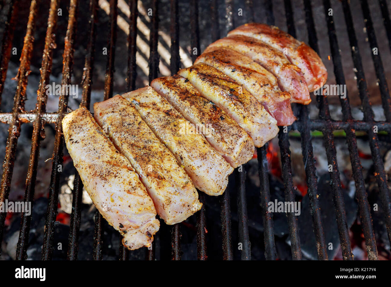 Steak burns on bbq Grilled pork steaks on the grill Stock Photo Alamy