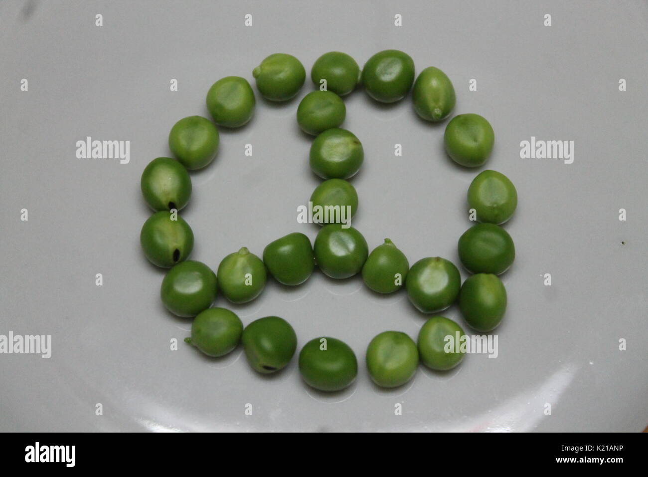 young sweet green color peas lay in symbol of peace prepare for cooking Stock Photo