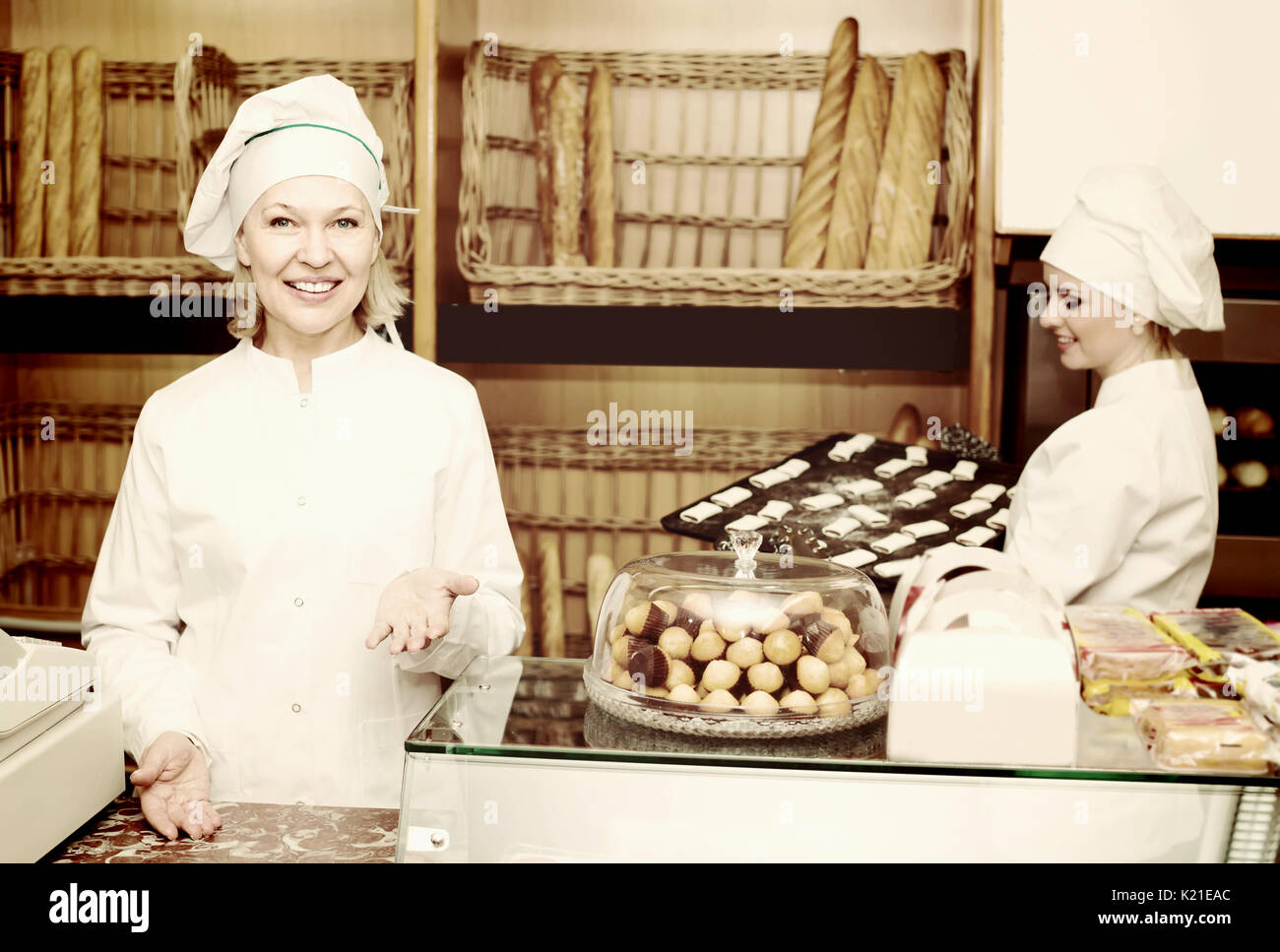 Portrait of two joyful smiling female bakers in bakery Stock Photo Alamy
