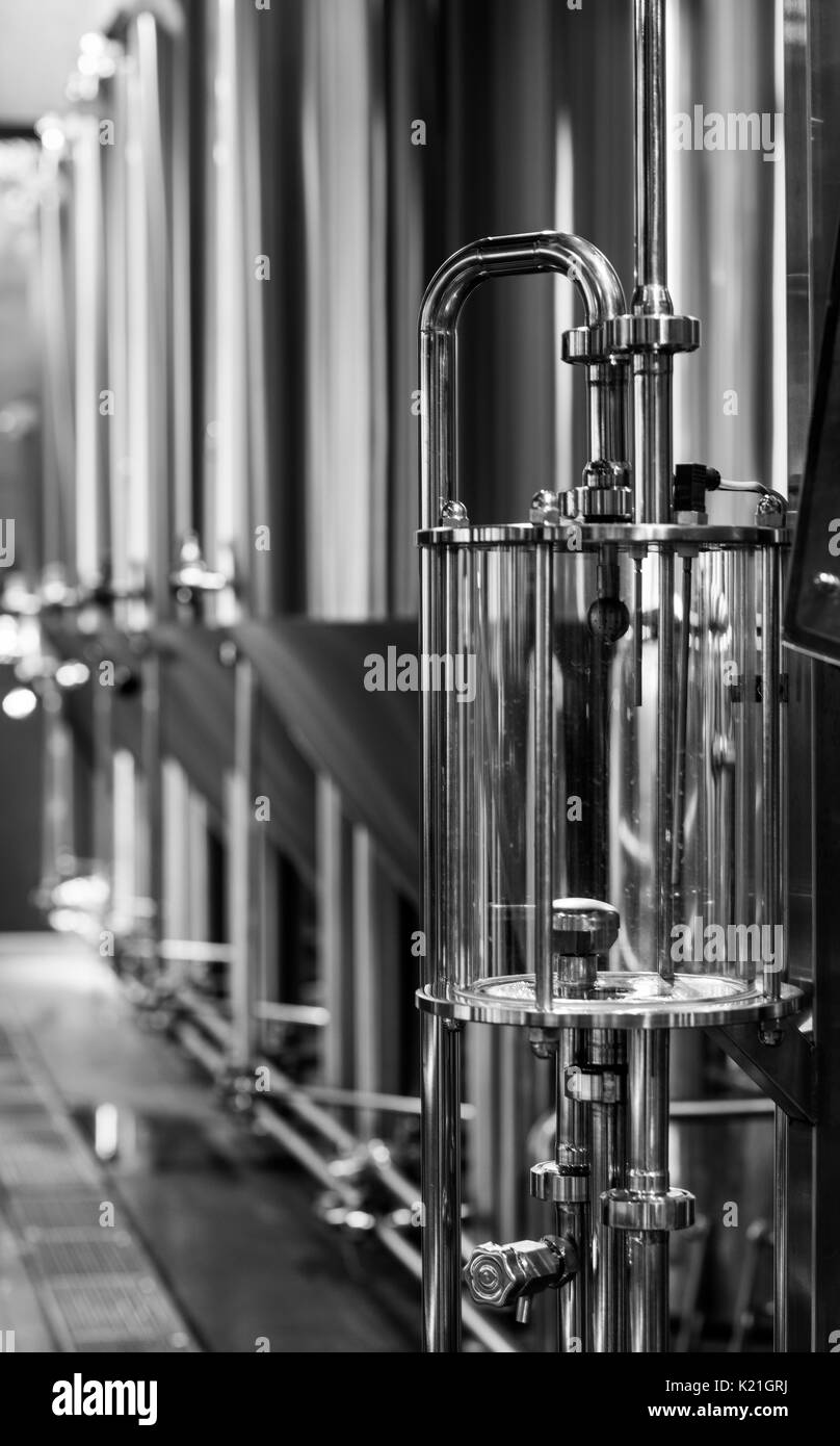Black and white photo of modern brewery equipment with stainless tanks for the fermentation beer Stock Photo