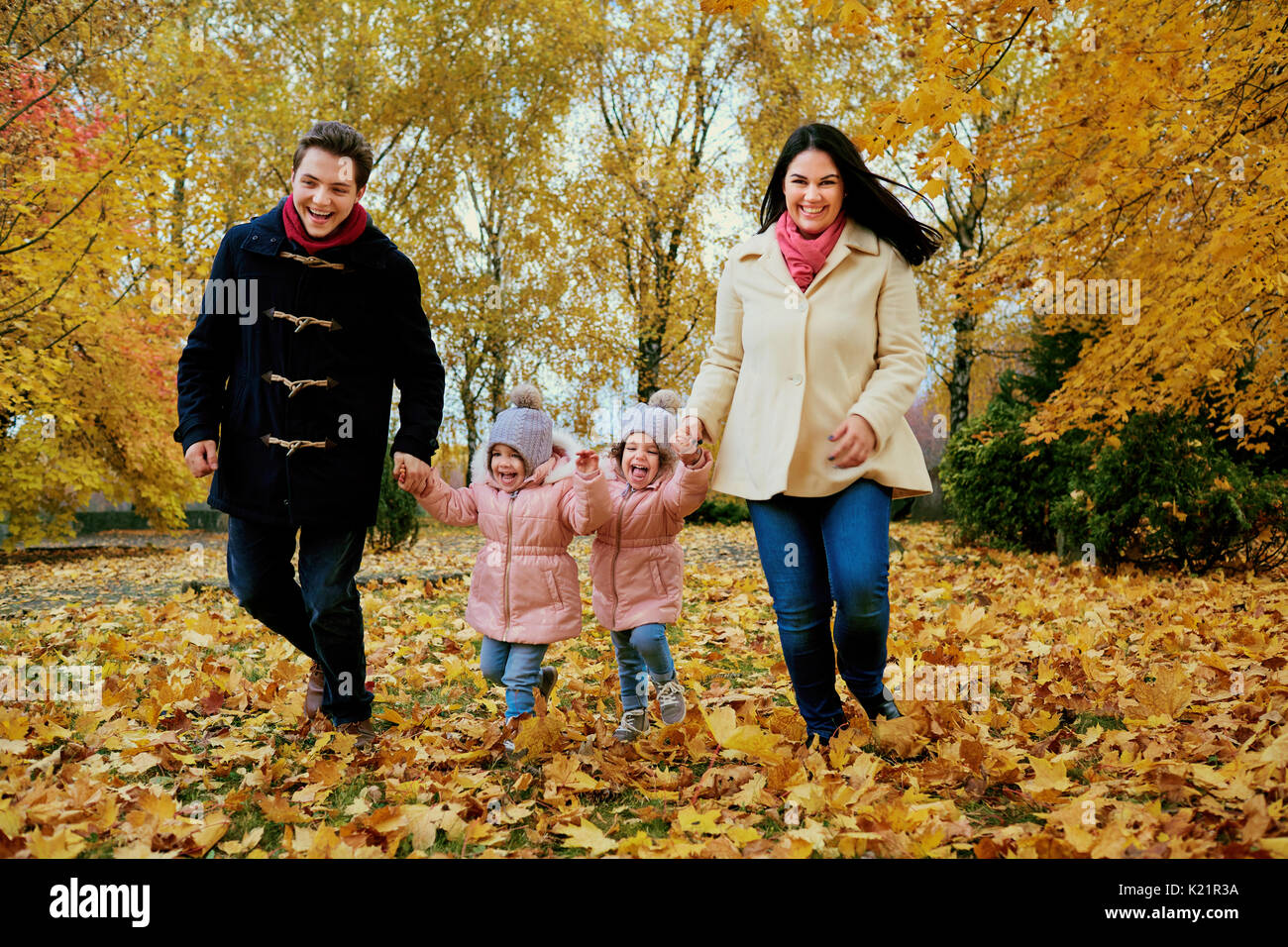 Happy family playing in autumn park. Stock Photo