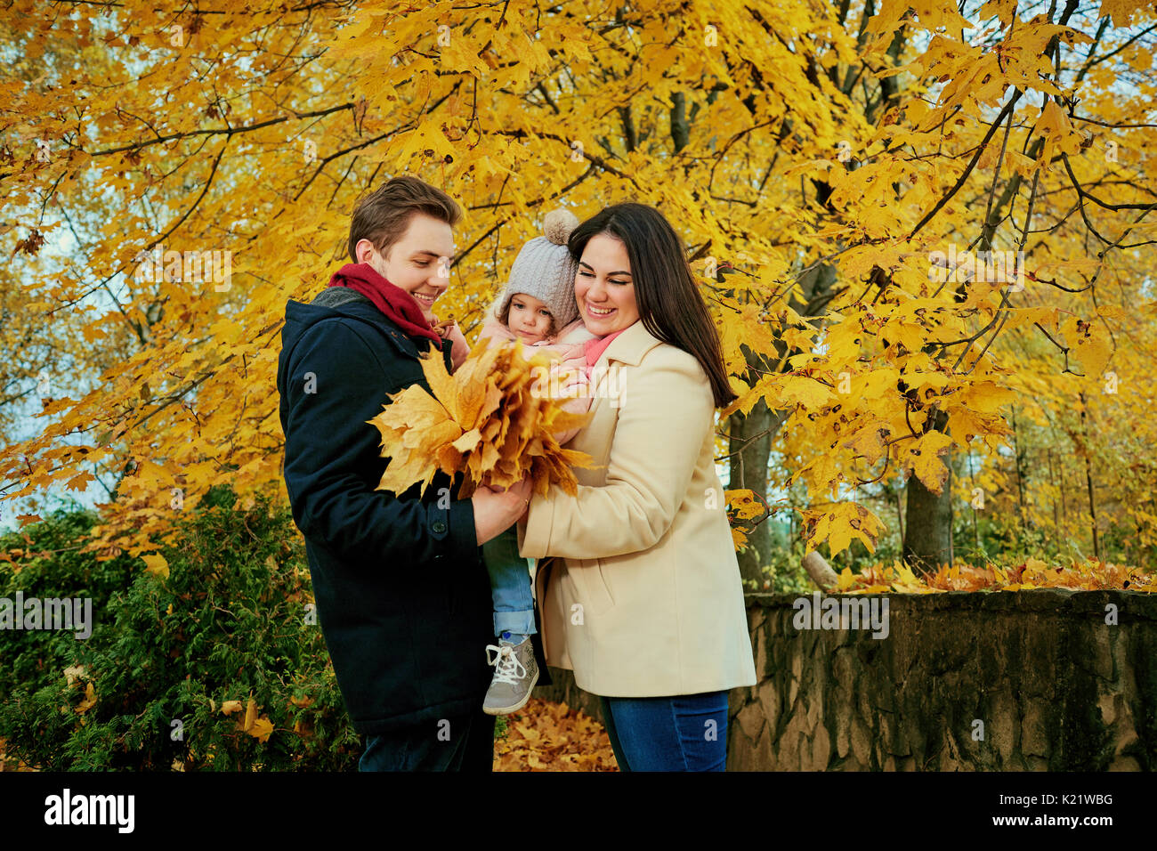 Family playing in the autumn in the park. Stock Photo