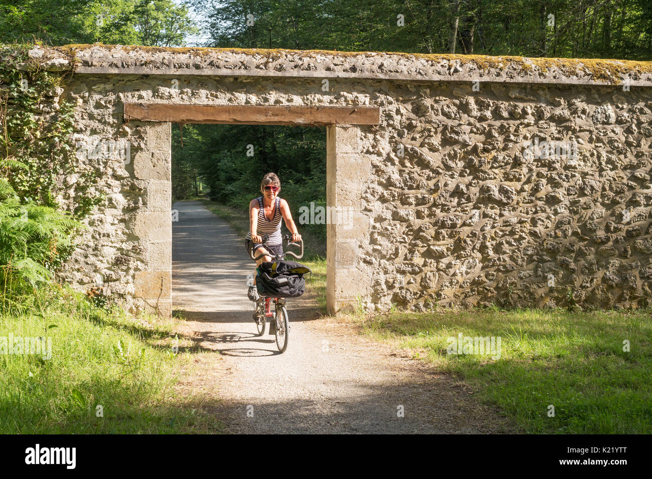 Mature woman riding Brompton bike on a cycle path in France, Europe Stock Photo