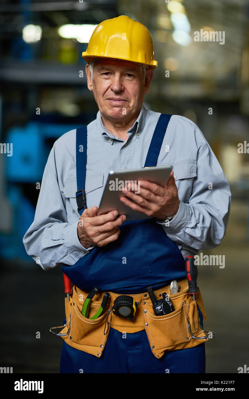 Senior Worker Posing with Digital Tablet Stock Photo