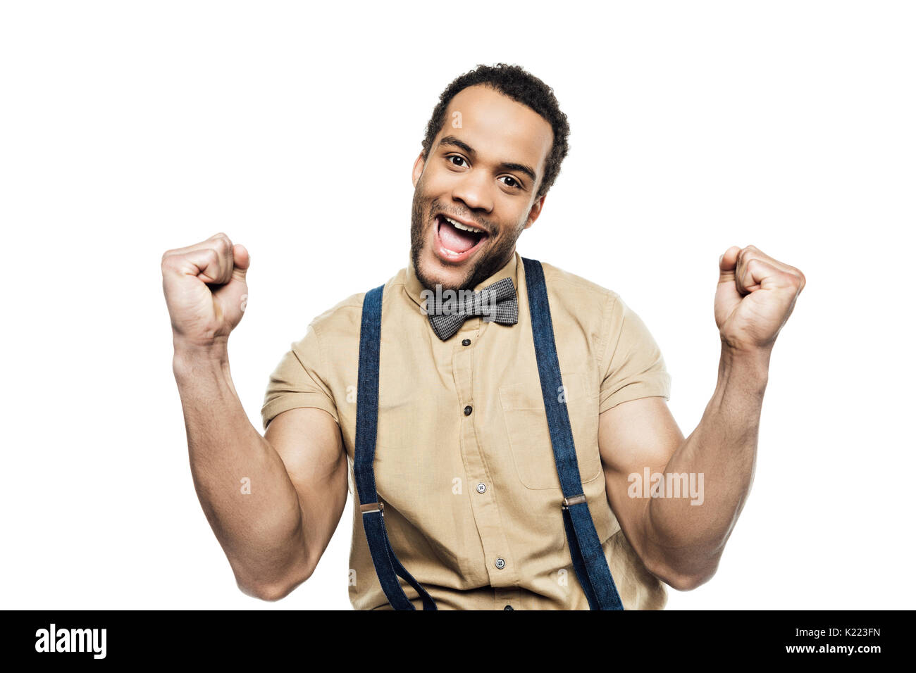 cheerful african american man wearing in suspenders and bow tie celebrating success isolated on white Stock Photo