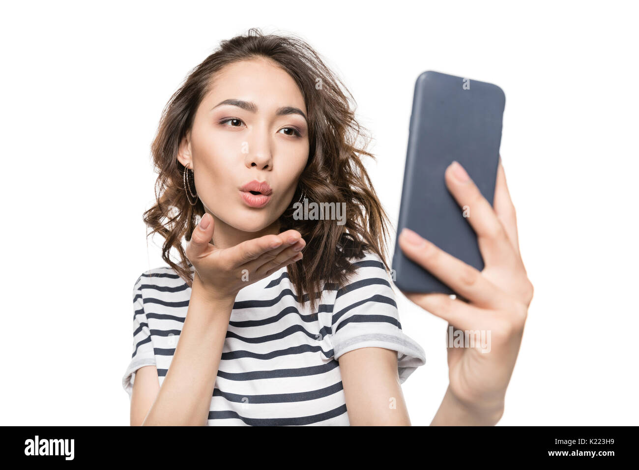 Woman Blowing Kiss While Taking Selfie On Smartphone Isolated On White