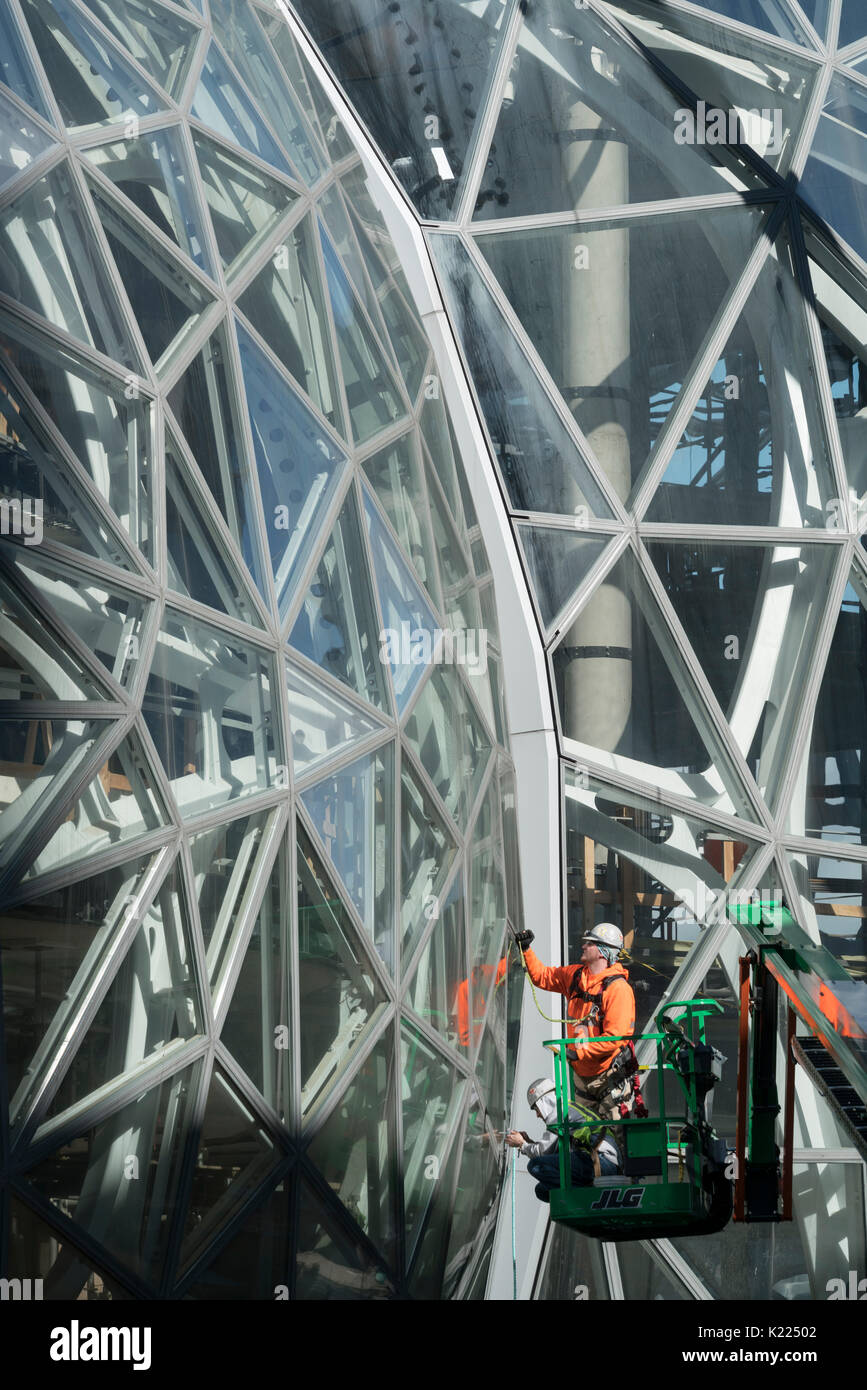 Workmen putting in glass in glass spheres of Amazon Corporate Headquarters, Seattle  Washington, USA Stock Photo