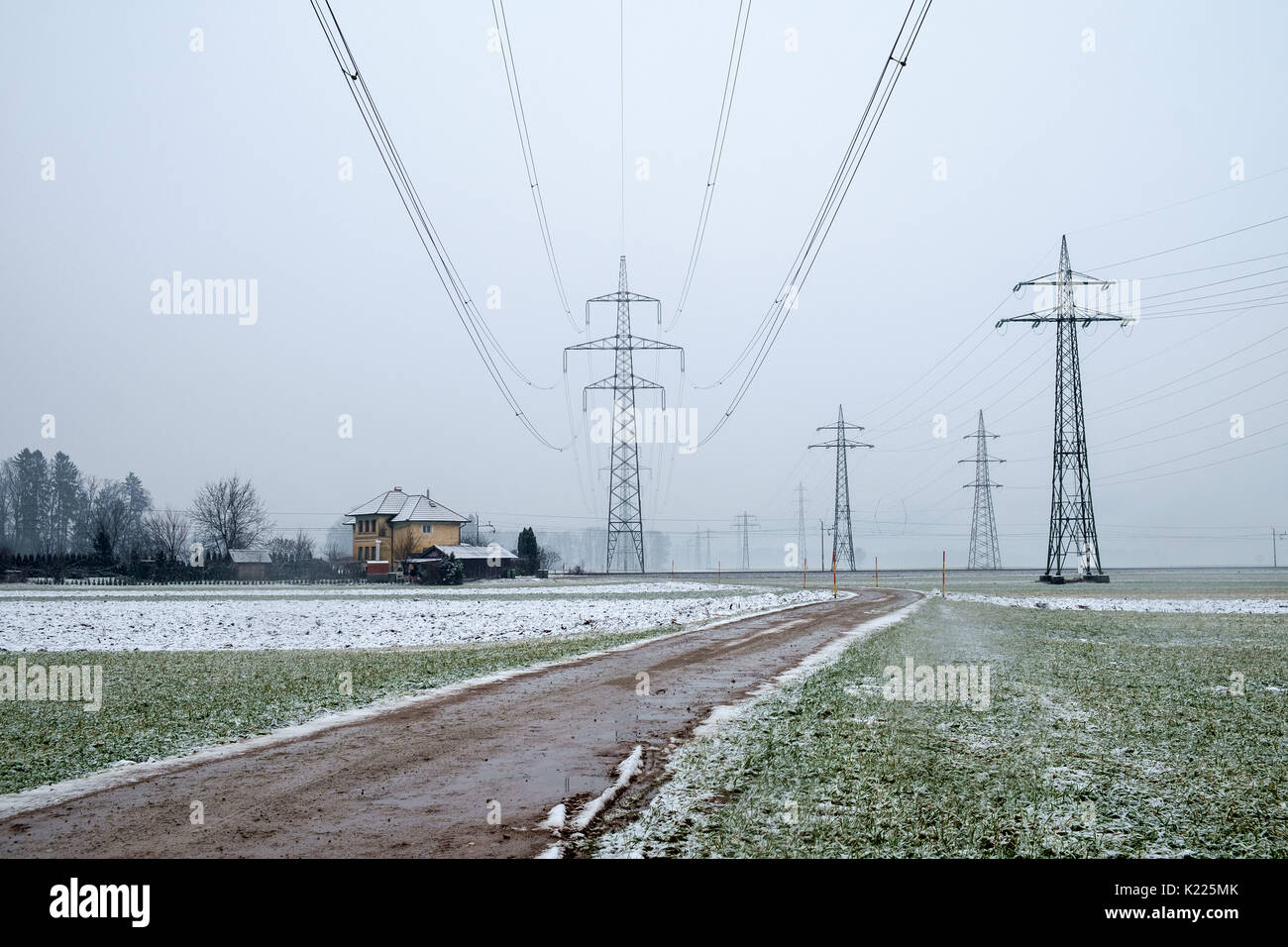Electric pylons in the winter field Stock Photo - Alamy