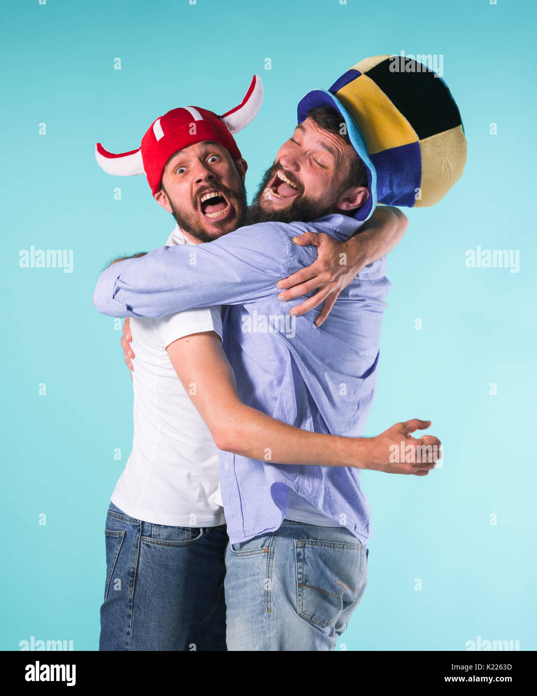 Two Excited Male Friends Celebrate Watching Sports Stock Photo