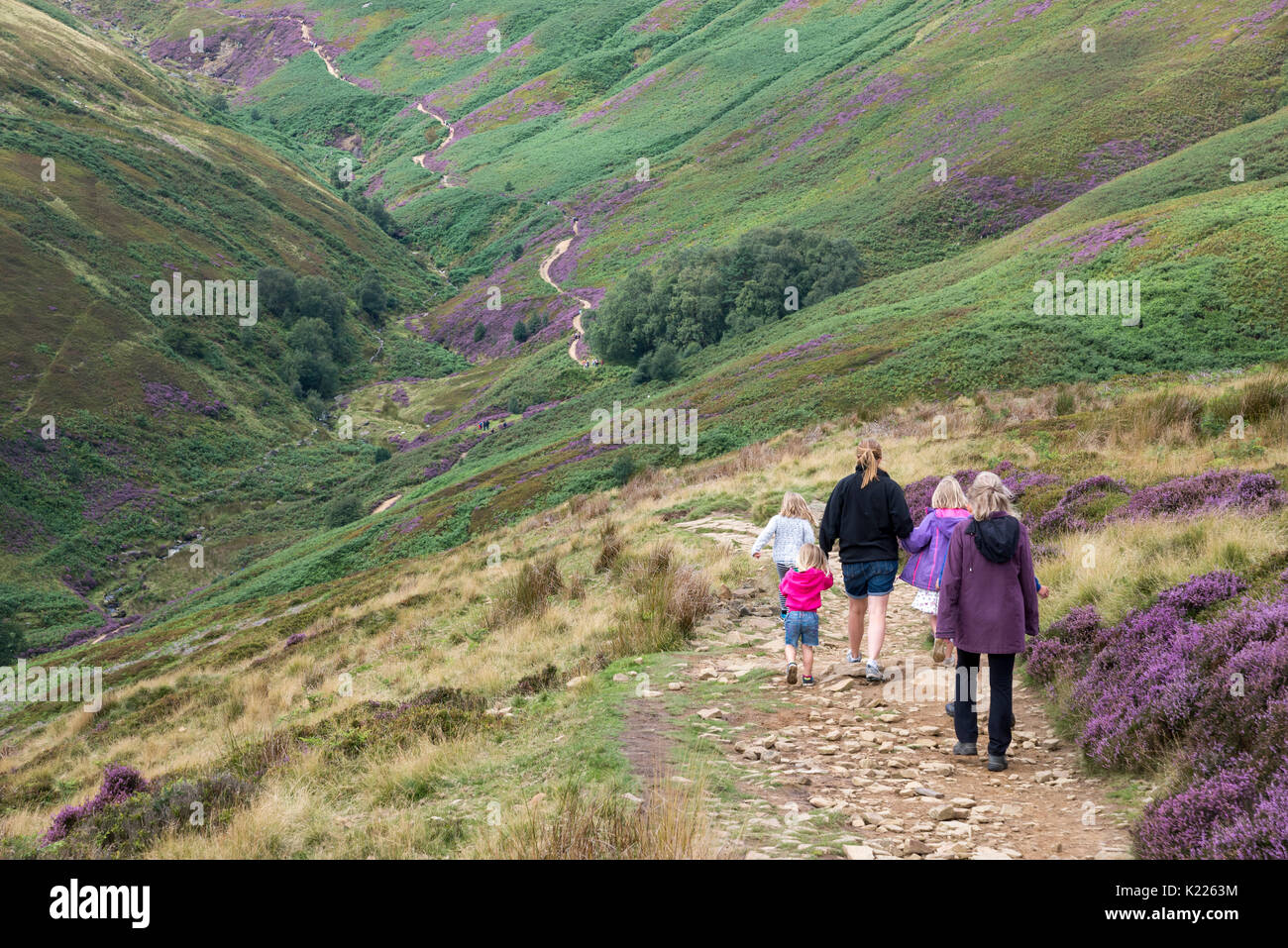 Family group of women and children enjoying a summer walk in the hills of the Peak District at Edale in Derbyshire, England. Stock Photo