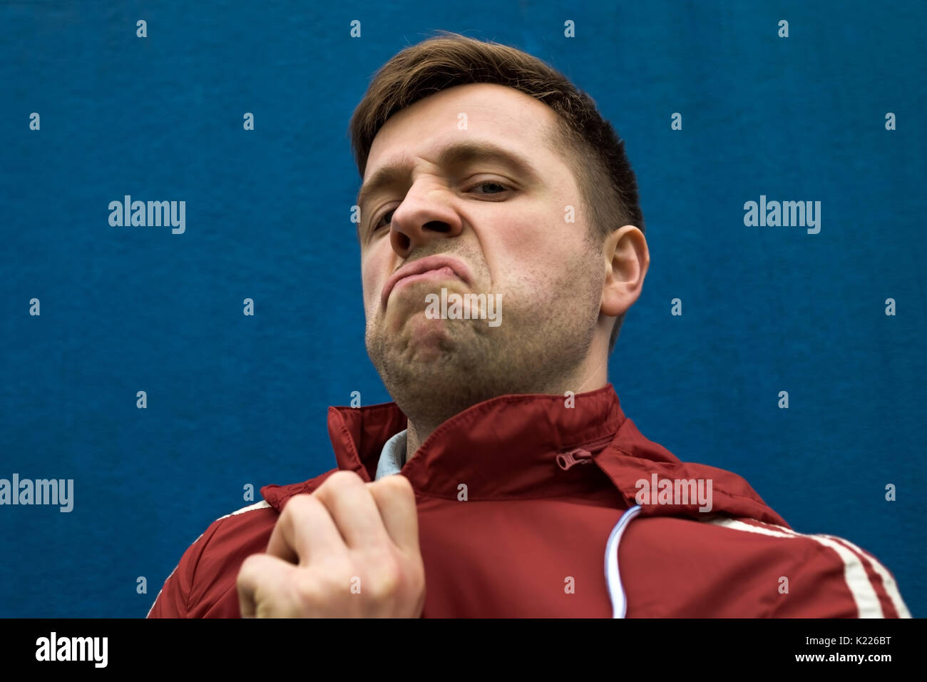 Portrait of caucasian young man with negative emotion on face Stock Photo