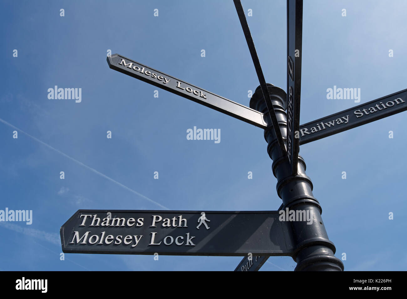 signpost in east molesey, surrey, england, giving directions to the