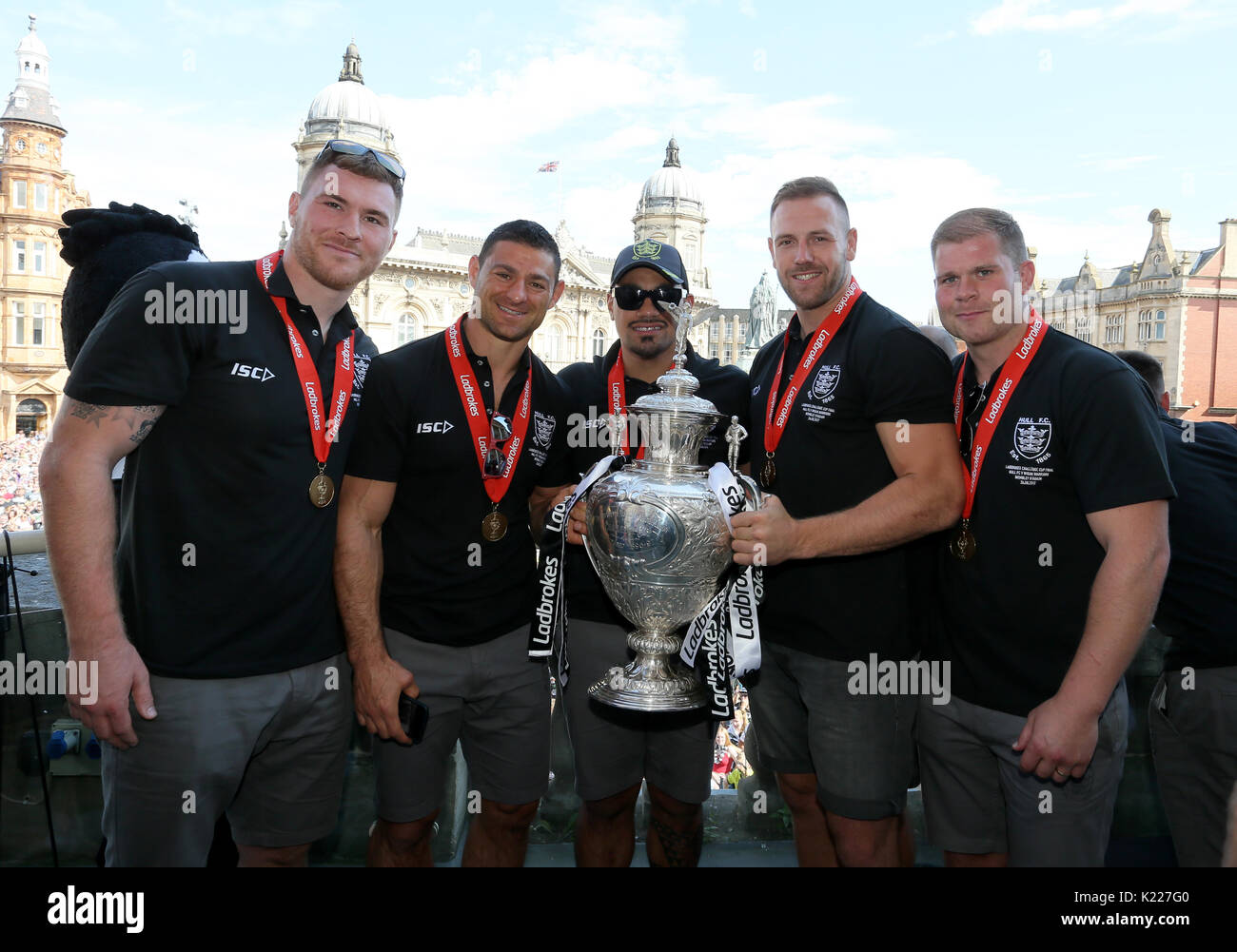 Hull FC players pose with the Ladbrokes Challenge Cup trophy during