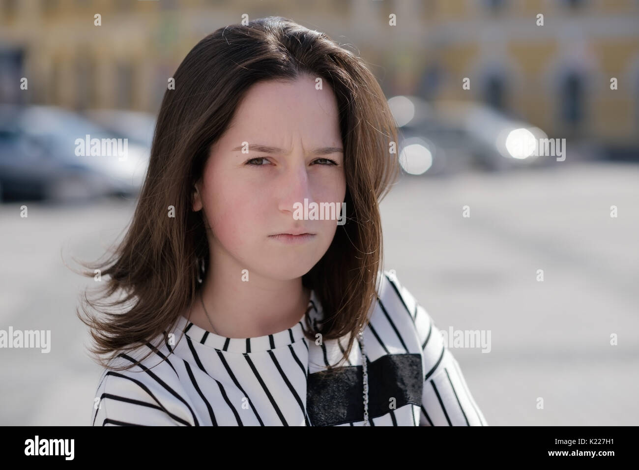 Lovely confused caucasian woman looking at camera with confused expression on face Stock Photo