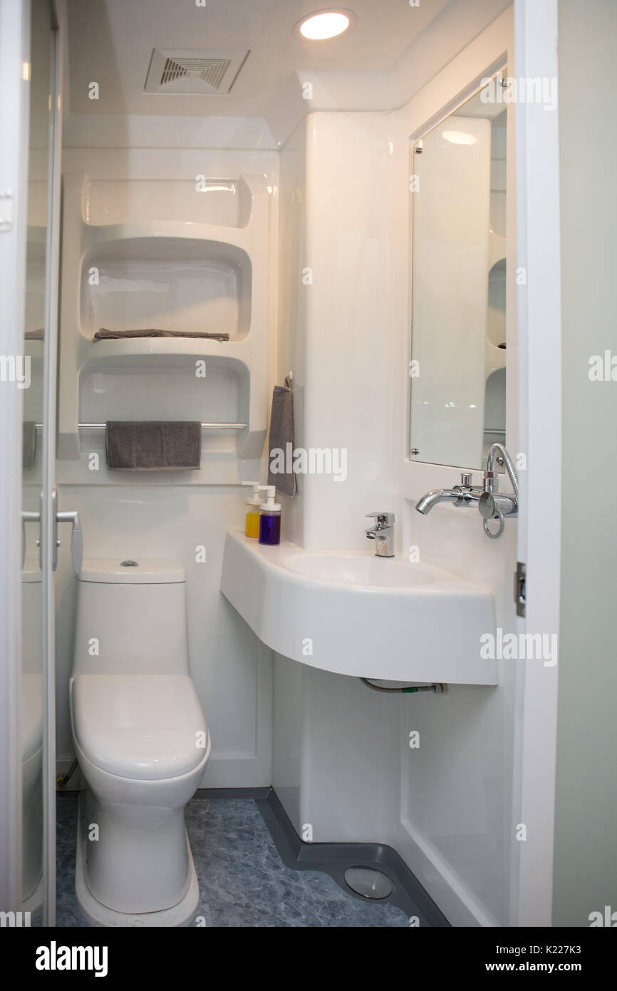 Interior of a modern minimalistic small bathroom with little sink Stock Photo