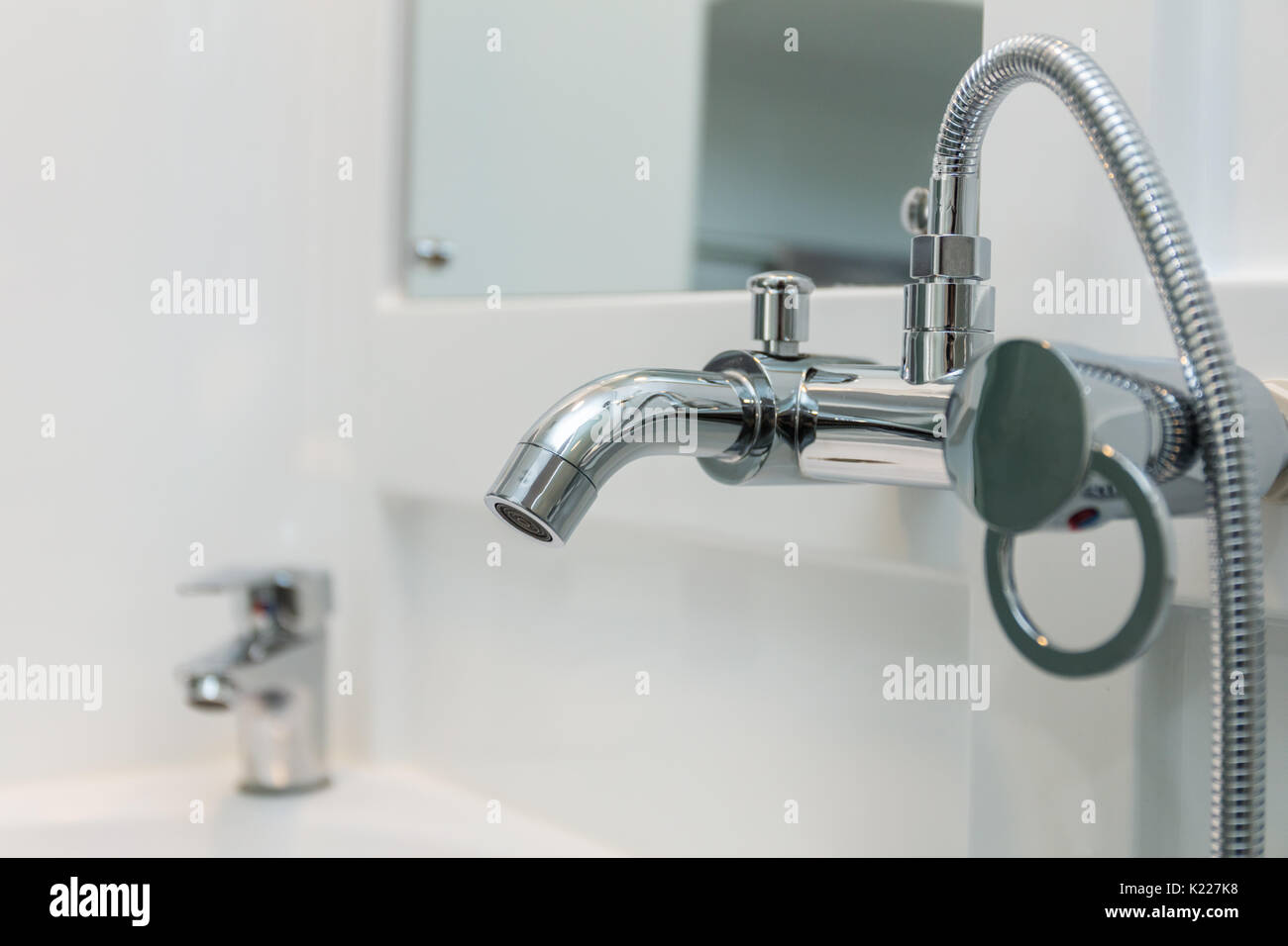 Close up of chrome bath shower tap in a modern bathroom Stock Photo