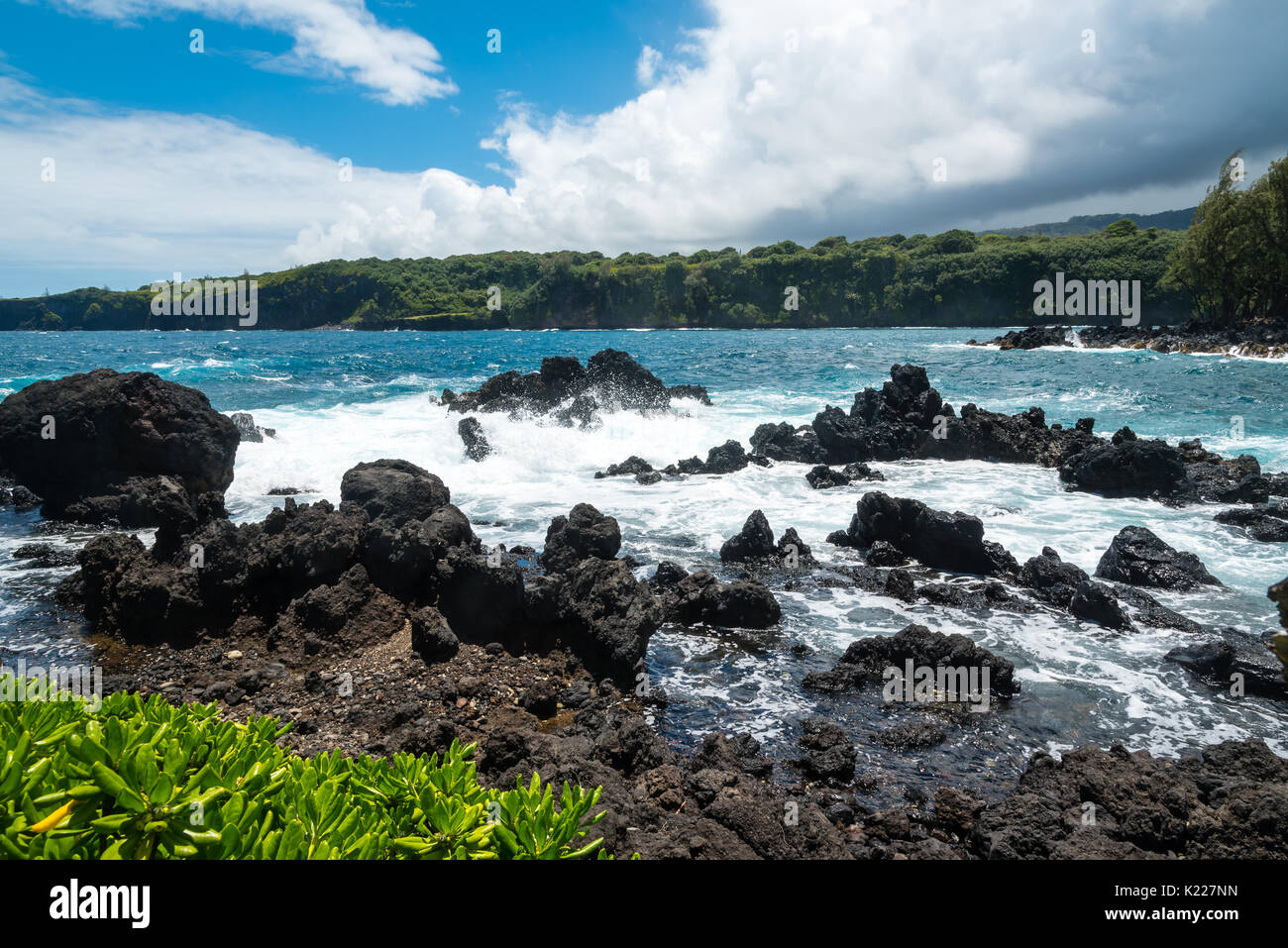 Surf hitting volcanic rocks on Maui, Hawaii Stock Photo