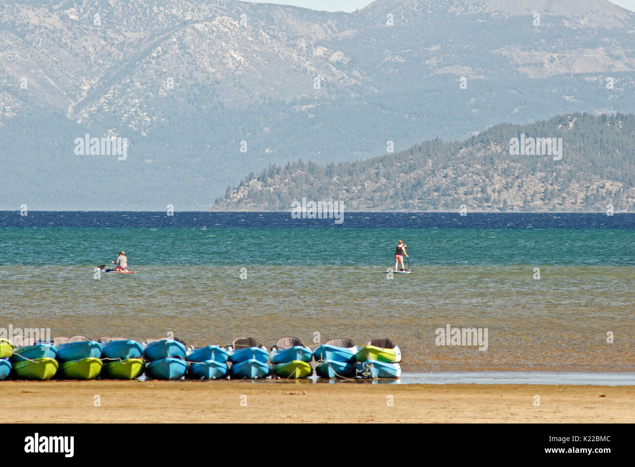 PADDLE BOARDERS USING LAKE TAHOE DURING DROUGHT, CALIFORNIA Stock Photo