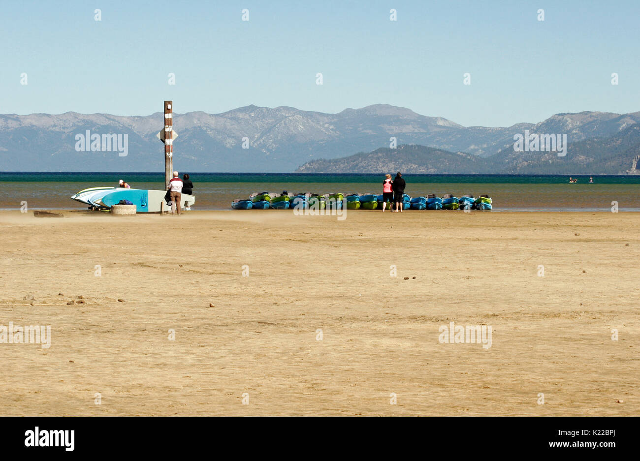 KAYAKS LINED UP ON THE DRY SHORES OF LAKE TAHOE DURING DROUGHT, CALIFORNIA Stock Photo