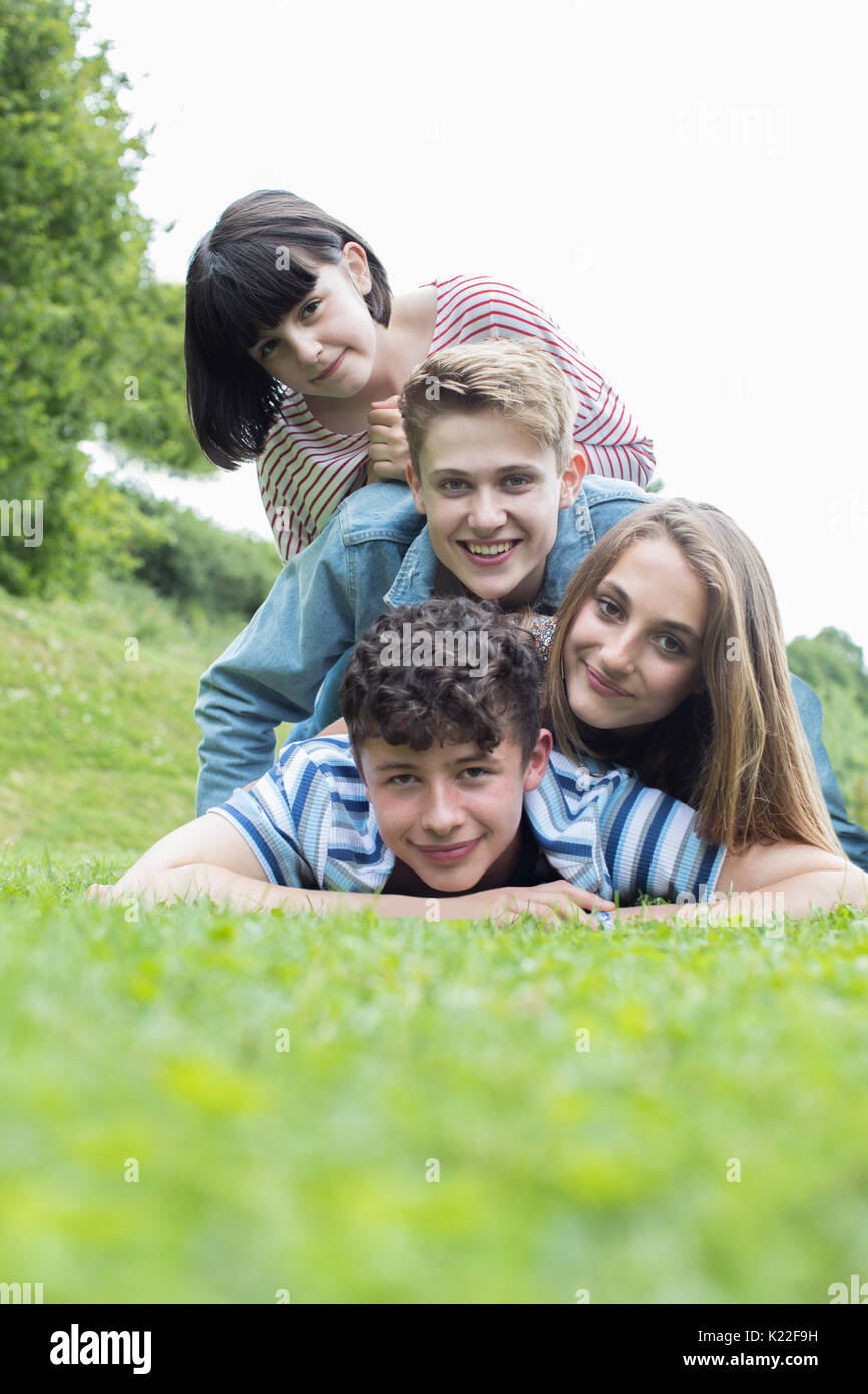 Group Of Teenage Friends Lying On Grass Together Stock Photo