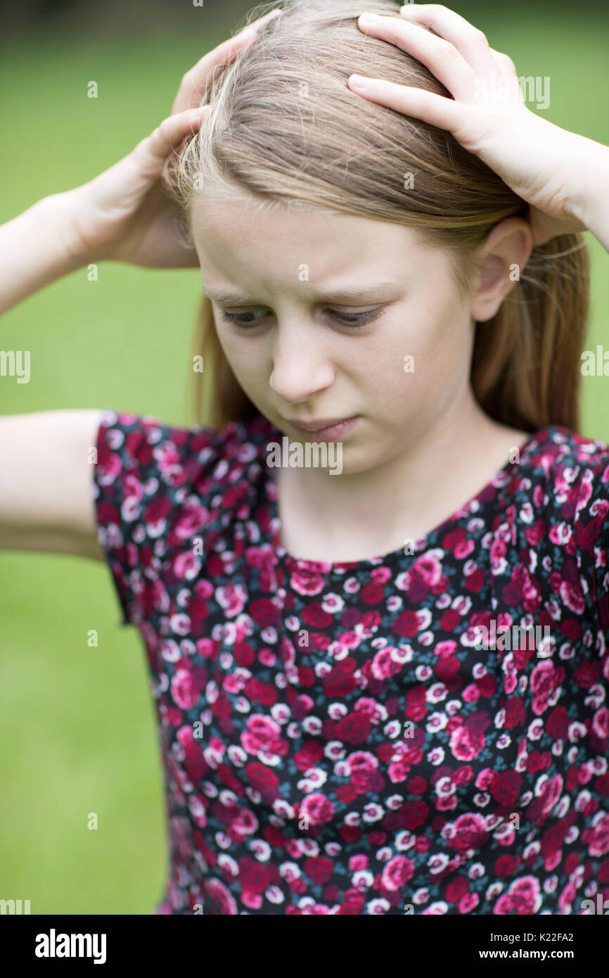 Outdoor Portrait Of Stressed Young Girl Stock Photo