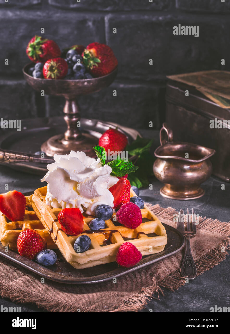Belgian waffles with whipped cream and fresh berries in vintage style ...