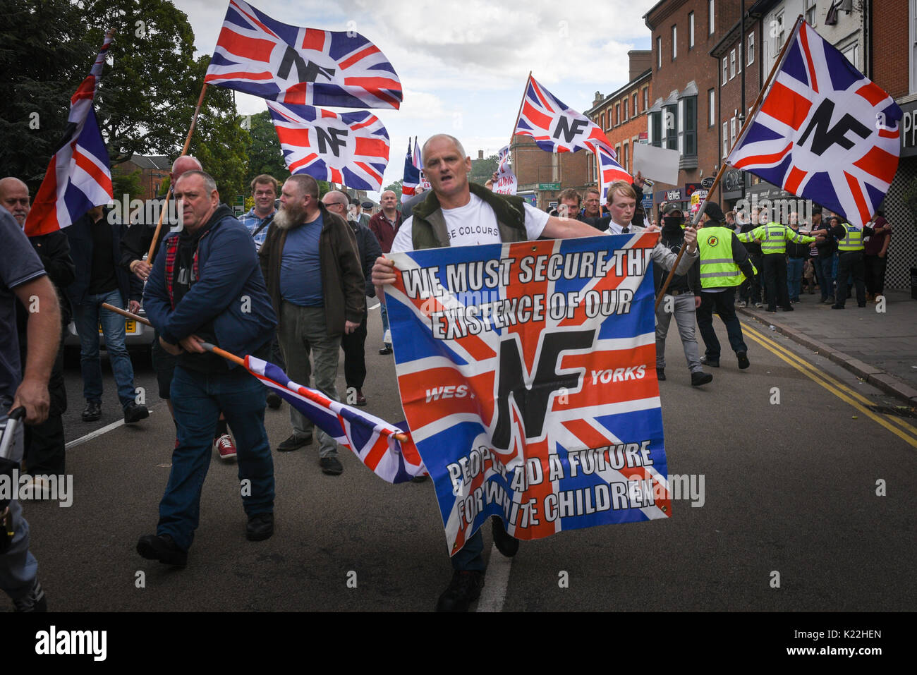 Grantham, Lincolnshire, UK. 19th August 2017. Pictured:  National Front supporters march through the centre of Grantham. / Up to 60 anti-fascists clas Stock Photo