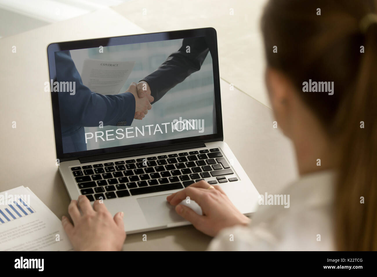 Businesswoman watching business presentation, looking at laptop  Stock Photo