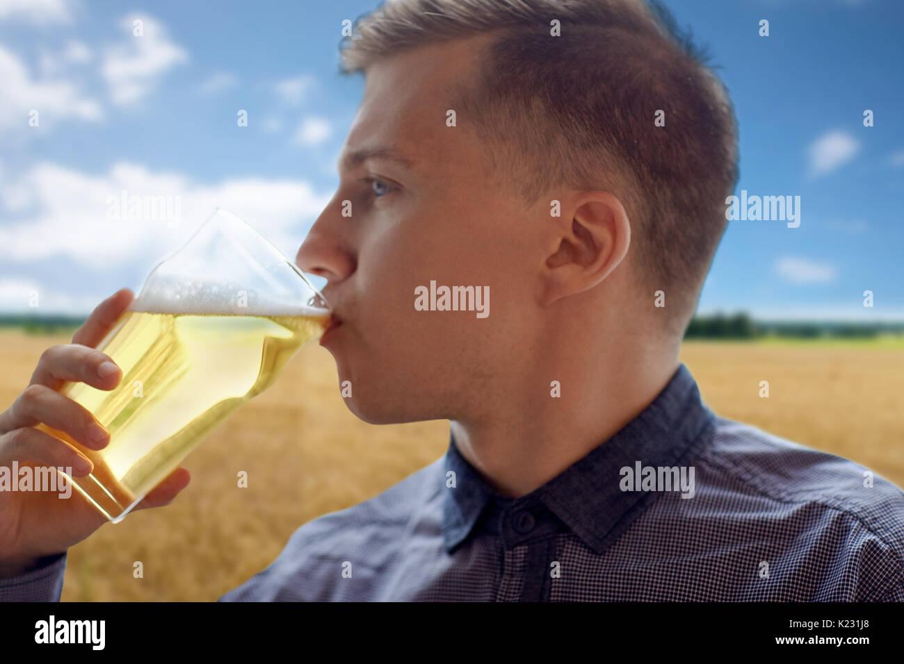 close up of young man drinking beer from glass Stock Photo Alamy