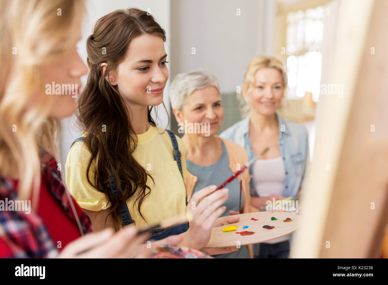 women with easel and palettes at art school Stock Photo - Alamy