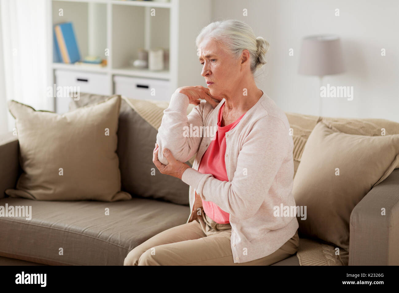 senior woman suffering from pain in hand at home Stock Photo - Alamy
