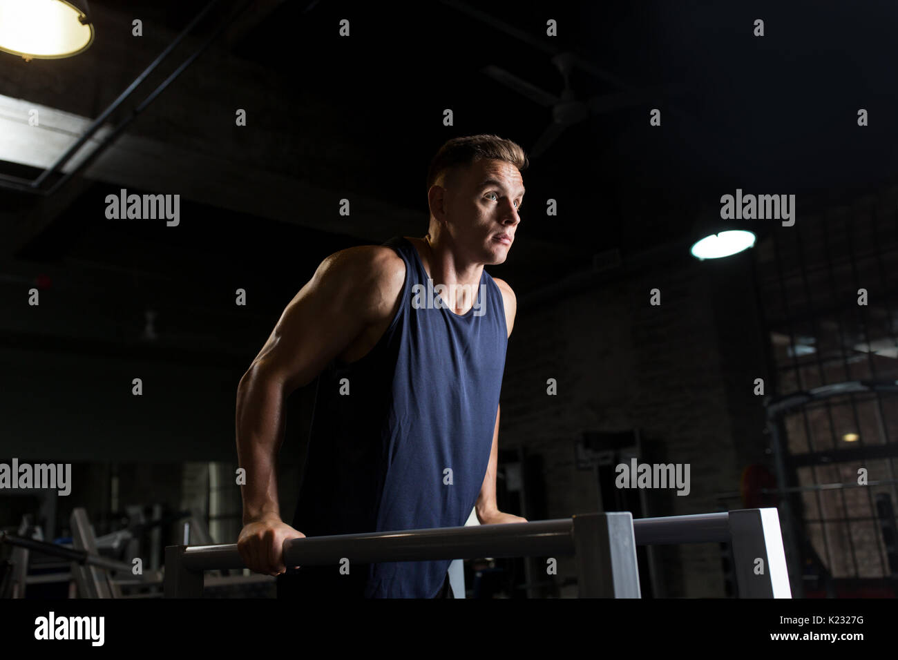 man doing triceps dip on parallel bars in gym Stock Photo Alamy