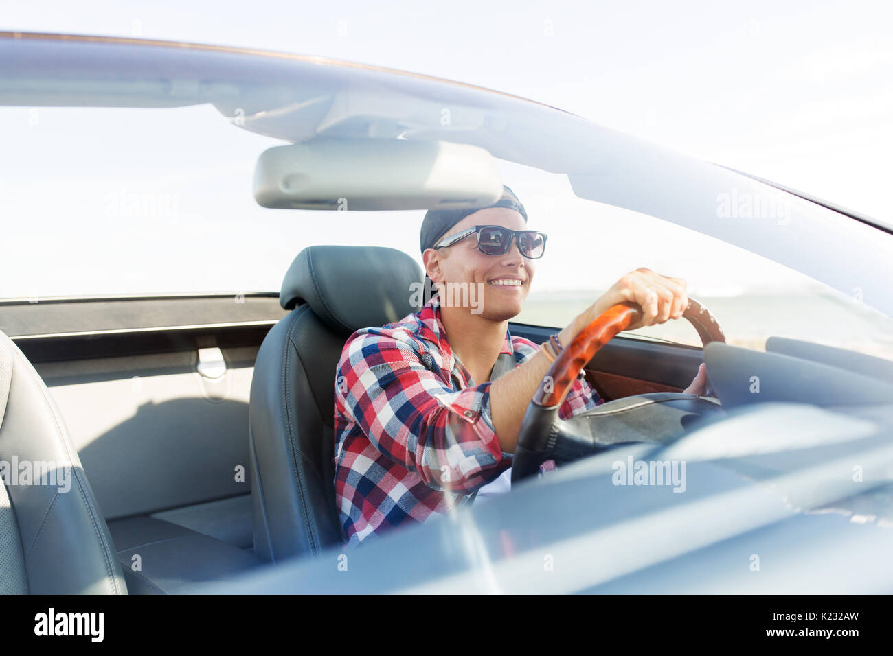 happy young man driving convertible car Stock Photo
