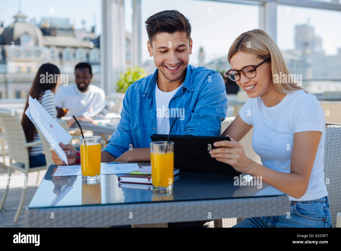 Cheerful groupmates working on project together Stock Photo