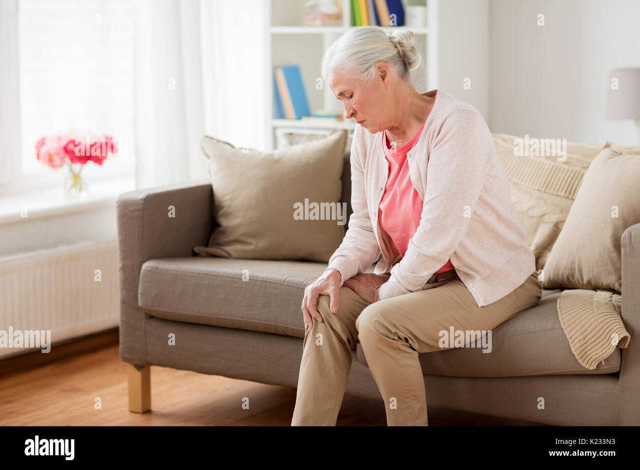 senior woman suffering from pain in leg at home Stock Photo - Alamy