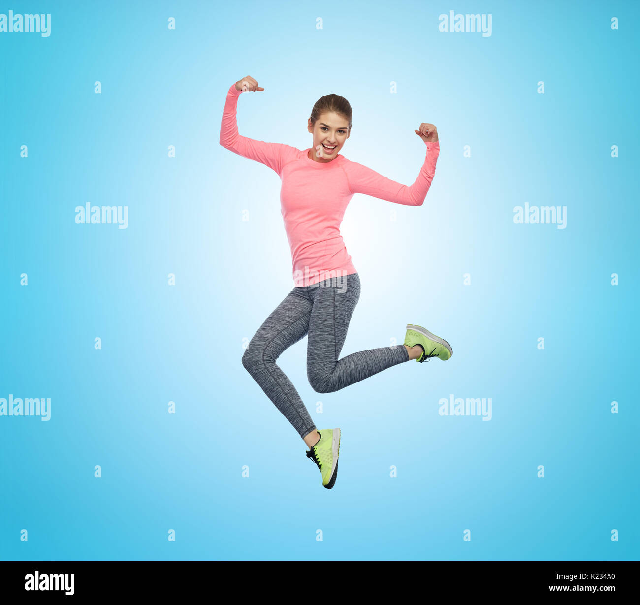 happy smiling sporty young woman jumping in air Stock Photo - Alamy