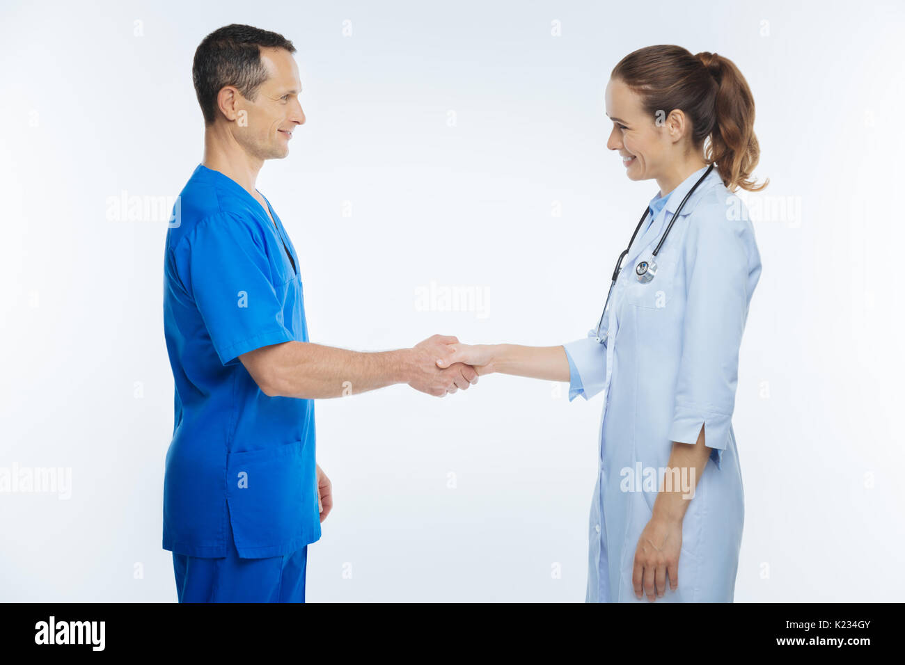 Friendly medical professionals shaking hands Stock Photo Alamy