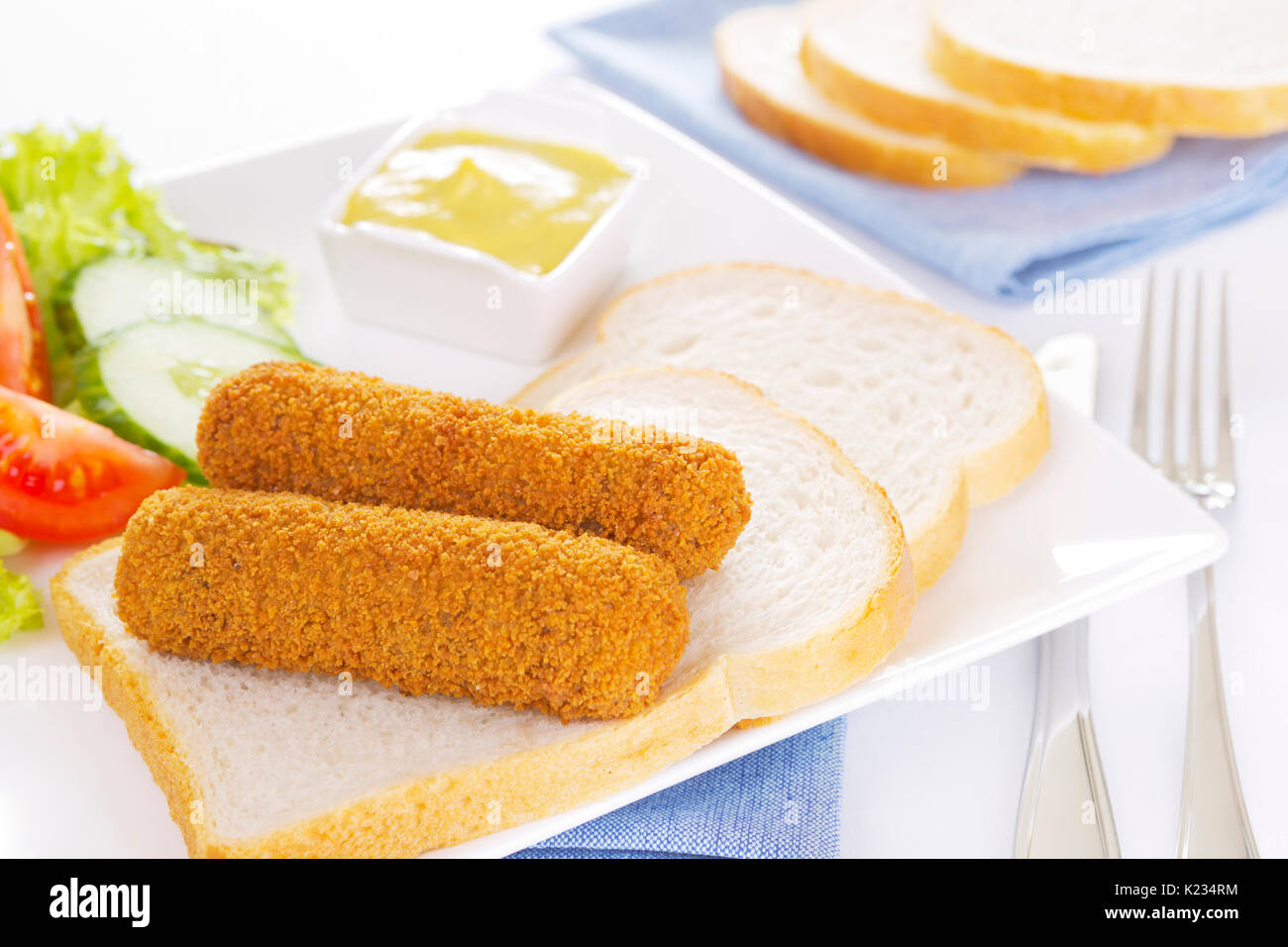 Deep fried Dutch meat croquettes ('kroket') and bread on a plate Stock